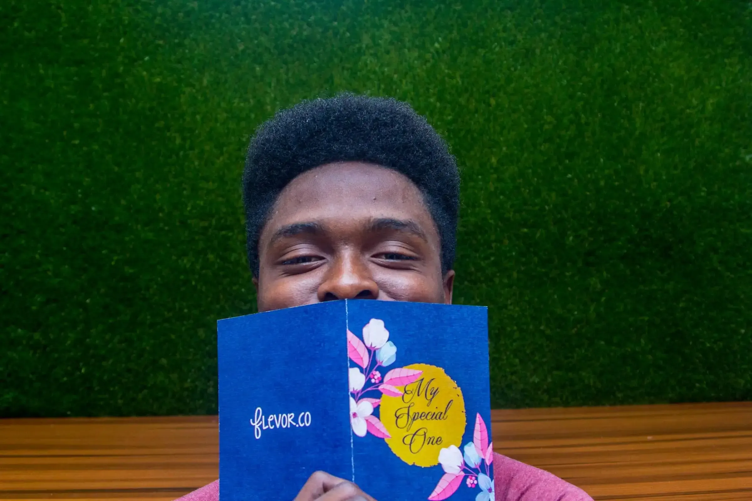 a joyful man holding a book with a vibrant cover