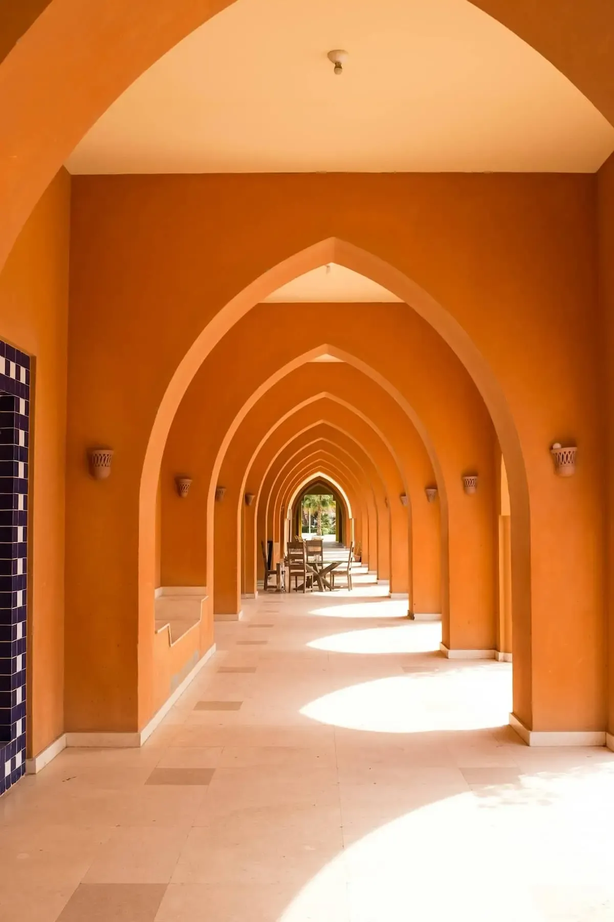 a hallway of arches during a bright day