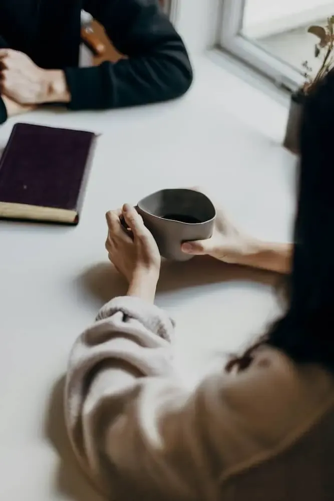 two people meeting over coffee